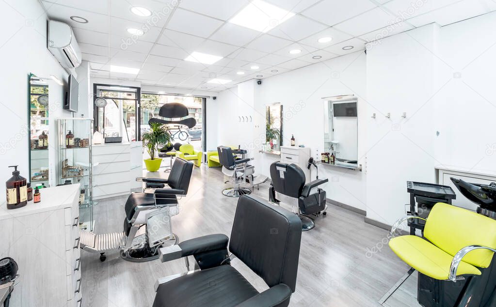 Panorama of a modern bright hair and beauty salon. Barber salon interior business with black and white luxury decor.