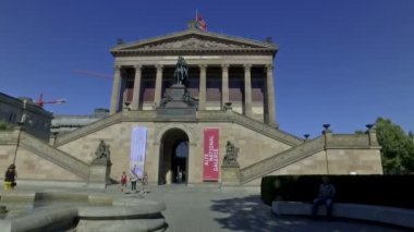 Berlin, Almanya. Mayıs 2018. Berlin Ulusal Galerisi 'nin fotoğrafını çeken turist. Ağır çekimde sinematik kamera hareketi..
