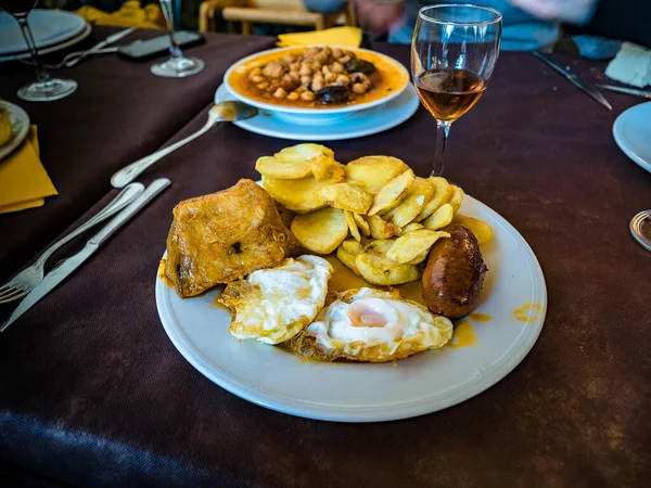 Spanish food. A combination plate fried potatoes, fried eggs, chorizo,black sausage and pork cooked in lard
