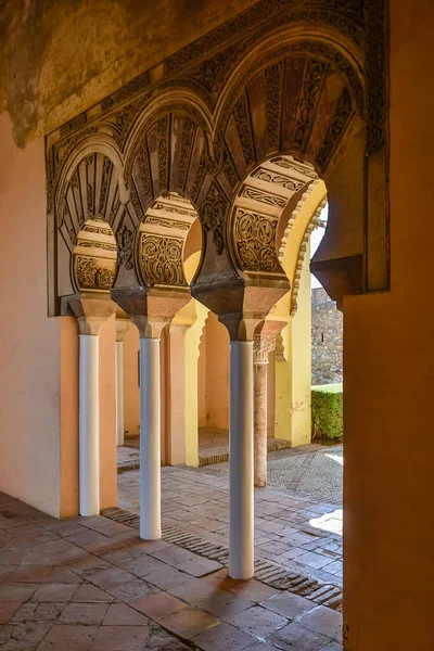Carved arches of the interior of the Alcazaba arab castle in Malaga, Spain.