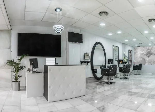 Masası, bitkisi ve afişi olan bir güzellik salonunda resepsiyon. Kuaför salonu..