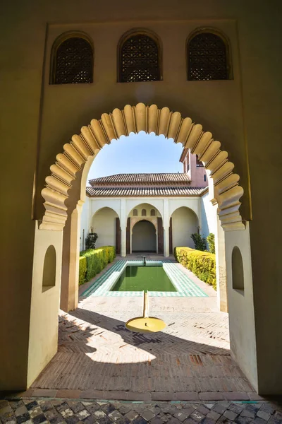 Carved arches of the interior of the Alcazaba arab castle in Malaga, Spain.