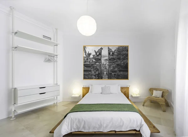 Clean bright bedroom with bed, duvet,side tables, lamps, photography. Minimalist white stylish interior