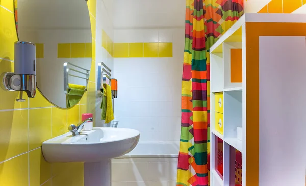 Baño moderno y colorido. Toallas y azulejos amarillos y naranjas . —  Fotos de Stock