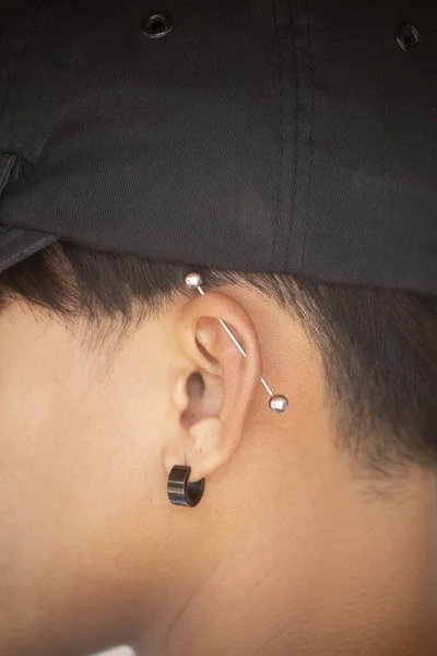 Pierced ear of young boy.