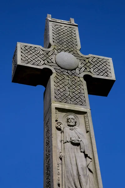 Stone Celtic Cross Against a Blue Sky