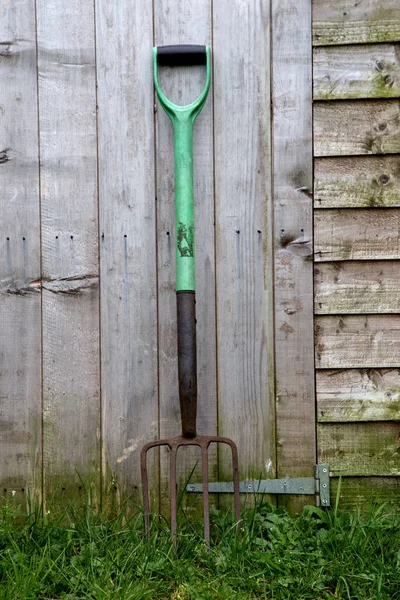 Old Gardening Fork and Wooden Shed