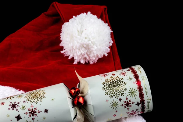 Christmas Santa Hat and Cracker on Black Background — Stok Foto