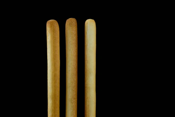 Breadsticks isolado contra um fundo preto — Fotografia de Stock