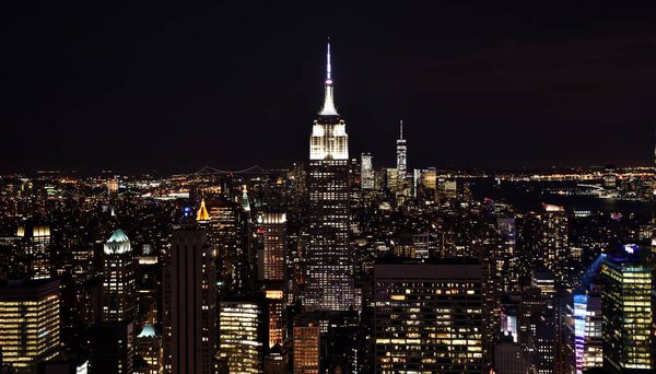New York City, USA - July 5, 2017: The Empire State Building, One World Trade Center, and the skyline of downtown Manhattan at night.