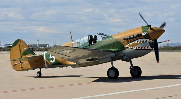 Tucson, USA - February 29, 2020: A vintage World War II-era Curtiss P-40 Warhawk fighter plane on the runway at Davis-Monthan Air Force Base in Tucson, Arizona.