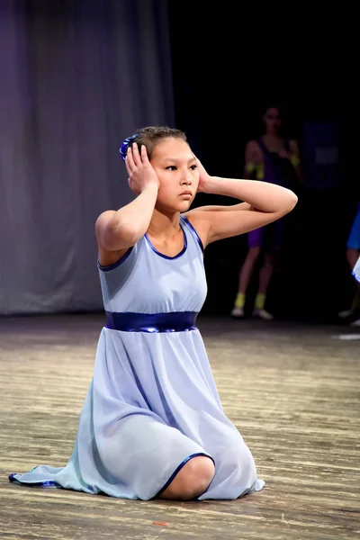 モダン ・ ダンス ・ ステージと、両手で耳を閉じるに座っている女の子. — ストック写真