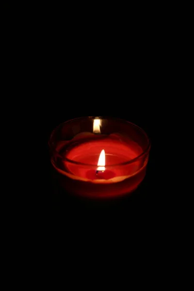 Red candle in a glass on black background — Stock Photo, Image