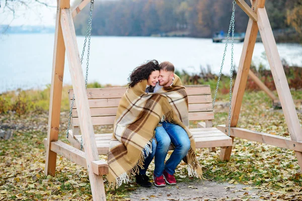 Amorous couple on romantic date on swings outdoor — Stock Photo, Image