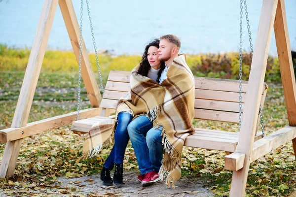 Amorous couple on romantic date on swings outdoor — Stock Photo, Image