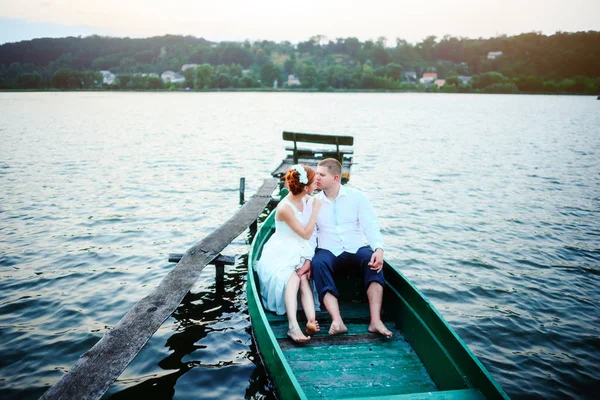 Young couple in love sitting in a small boat and having fun — Stock Photo, Image