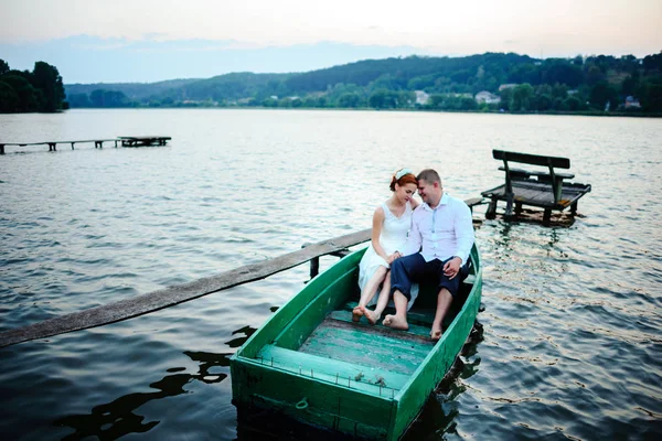 Young couple in love sitting in a small boat and having fun — Stock Photo, Image