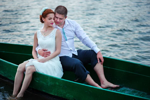 Young couple in love sitting in a small boat and having fun — Stock Photo, Image