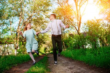 genç bir adam onun kız arkadaşı ile atlamak güneşli köyü de yol