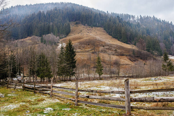 Pinewood fence on the background of winter Carpathian mountain