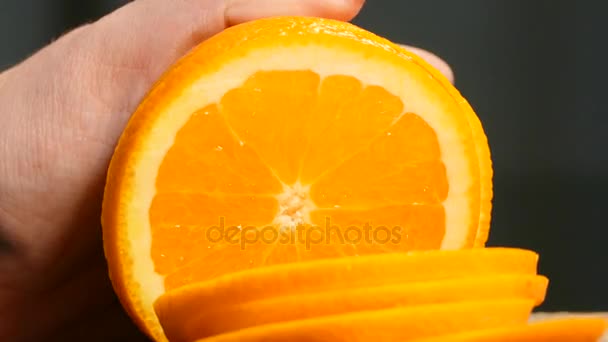 Close-up. Womens hands cut a juicy orange slices. — Stock Video