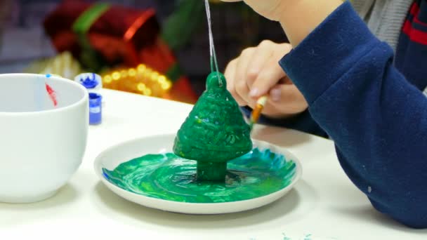 Il ragazzo dipinse completamente la decorazione sull'albero di Natale. — Video Stock