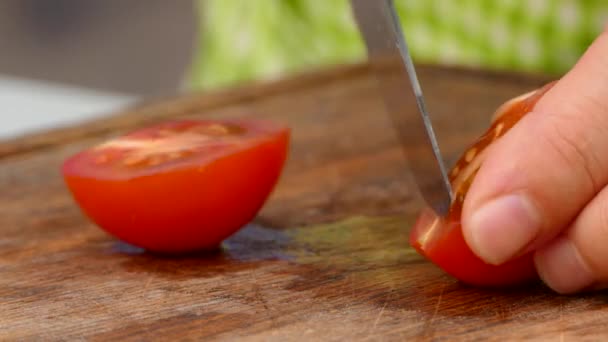 Der Koch schneidet eine Tomate in Scheiben — Stockvideo