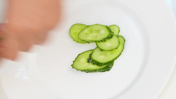 Gently collect the sliced vegetables on a plate — Stock Video