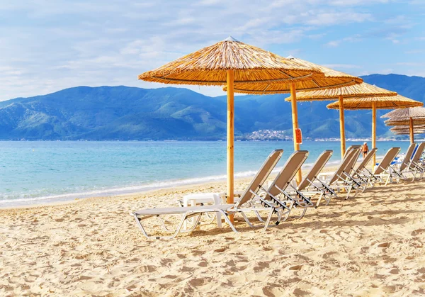 Grå halm paraply på vackra strand och hav och himmel — Stockfoto