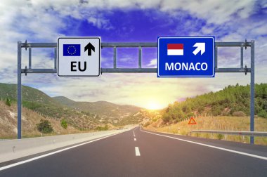 Two options EU and Monaco on road signs on highway clipart