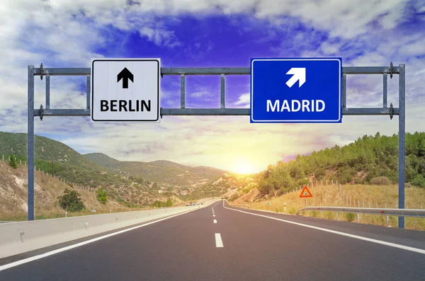 Two options Berlin and Madrid on road signs on highway — Stock Photo, Image