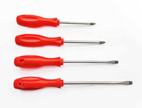 Four red shiny metal and plastic tool screwdriver for repair — Stock Photo, Image