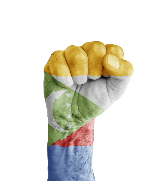 Emberi ököl, mint szimbólum győzelem festett Comore-szigetek zászlaja — Stock Fotó