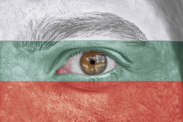 Human face and eye painted with flag of Bulgaria