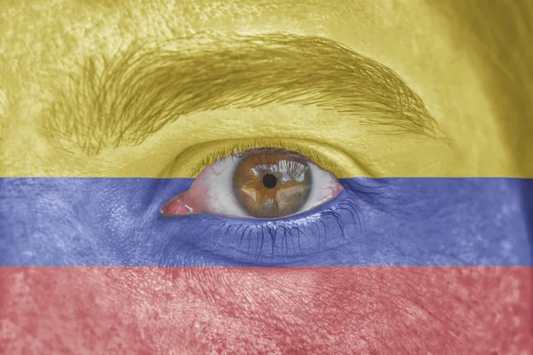 Rosto humano e olho pintado com bandeira de Columbia — Fotografia de Stock