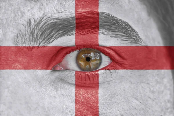 Human face and eye painted with flag of England