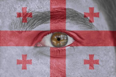 Human face and eye painted with flag of Georgia clipart
