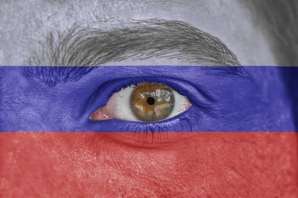 Rosto humano e olho pintado com bandeira da Rússia — Fotografia de Stock