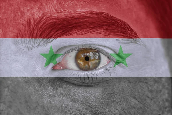 Human face and eye painted with flag of Syria — Stock Photo, Image