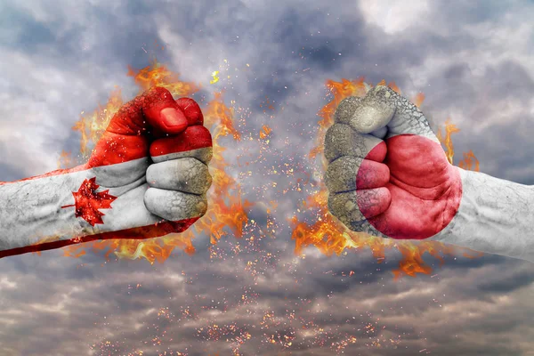 Two fist with the flag of Canada and Japan faced at each other ready for fight — Stock Photo, Image