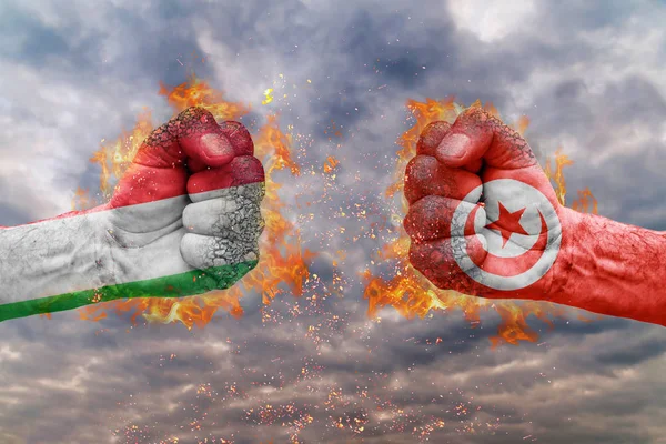 Two fist with the flag of Italy and Tunisia faced at each other ready for fight — Stock Photo, Image