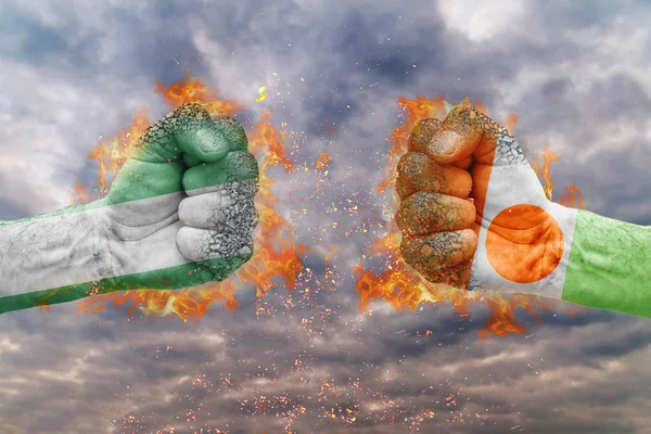 Два кулак з прапор Нігерії і Нігер стикаються один на одного готові до боротьби — стокове фото