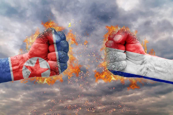 Kuzey Kore bayrağı ile iki yumruk ve Fransa birbirlerine karşı karşıya mücadele için hazır