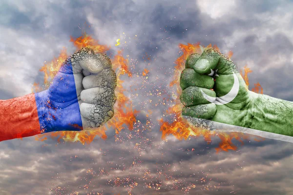 Two fist with the flag of Russia and Pakistan faced at each other ready for fight