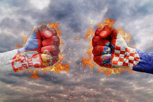 Two fist with the flag of Serbi and Croatia faced at each other ready for fight — Stock Photo, Image