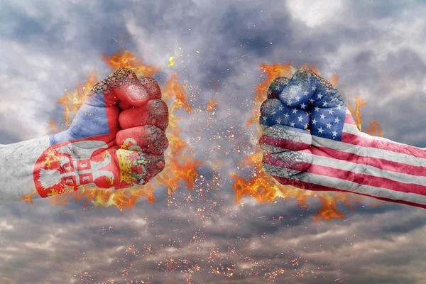 Two fist with the flag of Serbia and USA faced at each other ready for fight — Stock Photo, Image