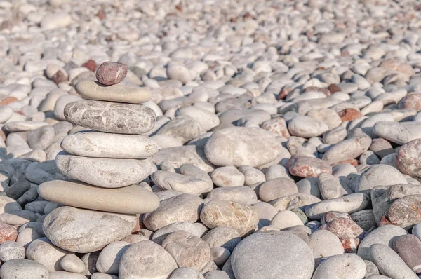 Several pebble stone complex like symbol for zen and relax concept on beach background — Stock Photo, Image