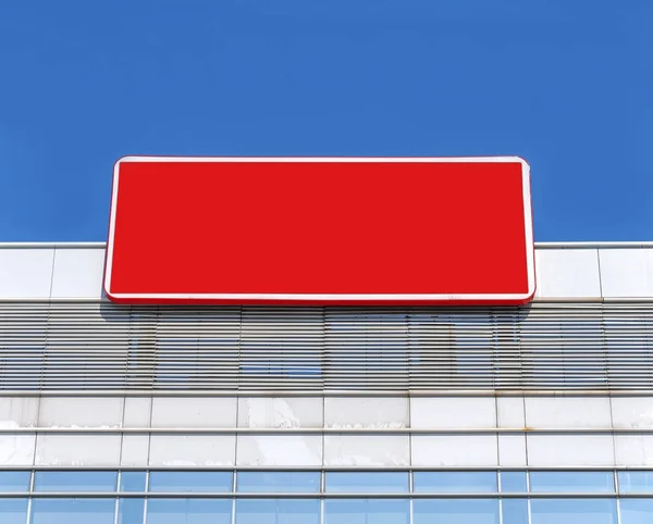 Empty billboard on building with red color and bluse sky