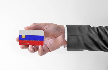 Bank credit plastic card with flag of Russia holding man in elegant suit 