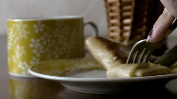 Frauenhände schneiden mit einem Tischmesser einen Pfannkuchen — Stockvideo